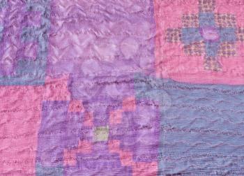 textile background - stitched pieces of silk fabric in patchwork scarf