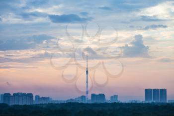 early blue and pink sunrise over Moscow city with Ostankino TV Tower and Timiryazevskiy park in summer morning