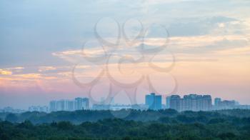blue and pink sunrise sky over Moscow city and Timiryazevskiy park in summer morning