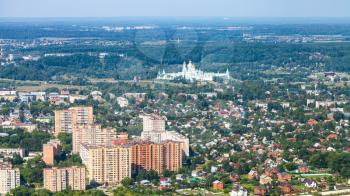above view of new apartment houses and cottages and New Jerusalem (Novoiyerusalimsky, Voskresensky Resurrection) Monastery in suburb of Istra town in Moscow Region in summer day