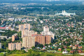 above view of urban houses and cottages and New Jerusalem (Novoiyerusalimsky, Voskresensky Resurrection) Monastery in suburb of Istra town in Moscow Region in summer day