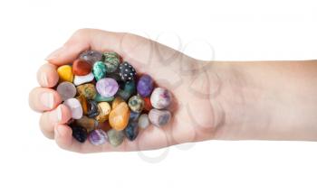 top view of handful with various gems isolated on white background