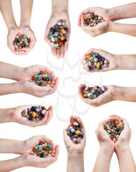 set of hands with handful of various natural gemstones isolated on white background