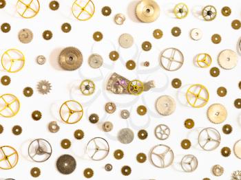 watchmaker workshop - pattern from various used watch spare parts on white background