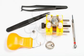 watchmaker workshop - kit for replacing battery in watch on white background