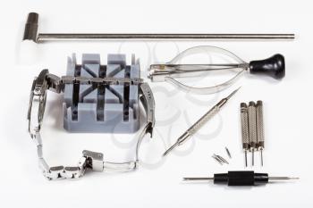 watchmaker workshop - watch repairing tool kit for adjusting watchband on white background
