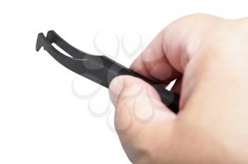 male hand with black plastic anti-static tweezers close up isolated on white background
