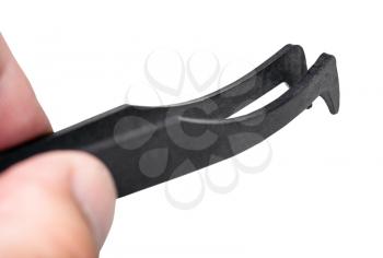male fingers hold black plastic anti-static tweezers close up isolated on white background