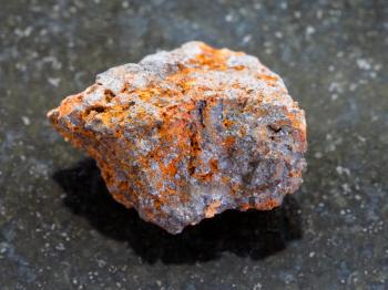 macro shooting of natural mineral rock specimen - raw Hematite (iron ore) stone on dark granite background