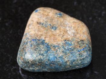 macro shooting of natural mineral rock specimen - polished azurite stone on dark granite background from Kazakhstan