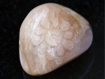 macro shooting of natural mineral rock specimen - Stilbite gemstone on dark granite background from India