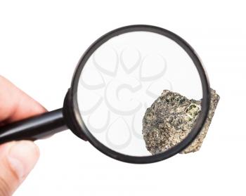 view of raw peridotite mineral through magnifier isolated on white background