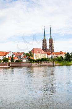 travel to Poland - view of Archbishop's Palace (Sufraganow palace) and Cathedrals and Cathedral of St John the Baptist on Ostrow Tumski island of Oder River in Wroclaw city in september