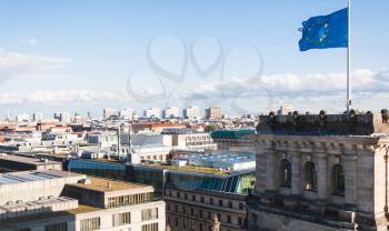 travel to Germany - above view of Berlin city and EU flag over Reichstag Palace in september