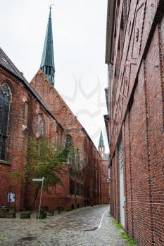 travel to Germany - narrow street near Bremen Cathedral in rain