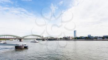 travel to Germany - pier and view of Rhine river with Hohenzollern Bridge (Hohenzollernbrucke) in Cologne city in september