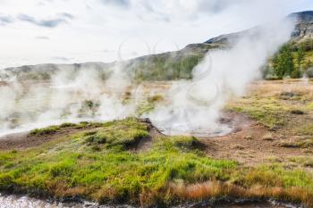 travel to Iceland - geyser pool in Haukadalur valley in autumn
