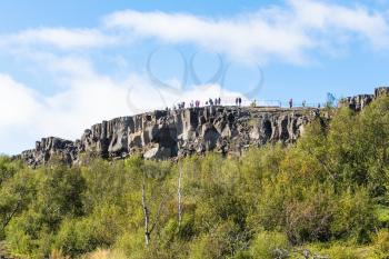 travel to Iceland - tourists at Observation Deck of Almannagja fault in Thingvellir national park in autumn