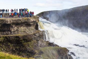 travel to Iceland - tourists at viewpoint over Gullfoss waterfall in september