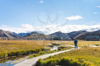 travel to Iceland - visitor on path to camp in Landmannalaugar area of Fjallabak Nature Reserve in Highlands region of Iceland in september