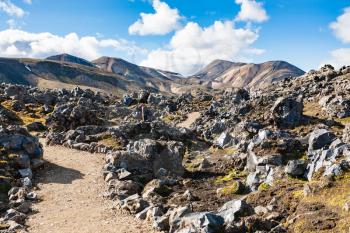 travel to Iceland - path between stones at Laugahraun volcanic lava field in Landmannalaugar area of Fjallabak Nature Reserve in Highlands region of Iceland in september