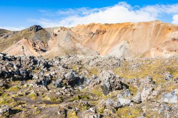 travel to Iceland - rocks and mountain near Laugahraun volcanic lava field in Landmannalaugar area of Fjallabak Nature Reserve in Highlands region of Iceland in september
