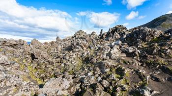 travel to Iceland - old rocks on volcanic slope at Laugahraun lava field in Landmannalaugar area of Fjallabak Nature Reserve in Highlands region of Iceland in september