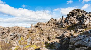 travel to Iceland - path between rocks on volcanic slope at Laugahraun lava field in Landmannalaugar area of Fjallabak Nature Reserve in Highlands region of Iceland in september