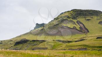 travel to Iceland - green mountain near Vik I Myrdal village on Atlantic South Coast in Katla Geopark in september
