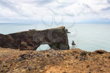 travel to Iceland - view of stone arch on Dyrholaey promontory near Vik I Myrdal village on Atlantic South Coast in Katla Geopark in september