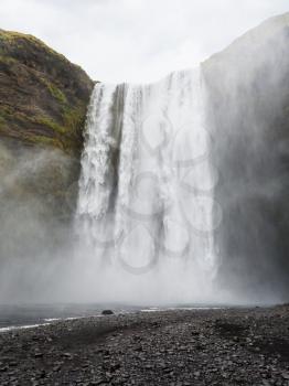 travel to Iceland - view of Skogafoss waterfall in Katla Geopark on Icelandic Atlantic South Coast in september