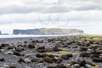 travel to Iceland - boulders on Reynisfjara black beach in Iceland, near Vik I Myrdal village on Atlantic South Coast in Katla Geopark in september