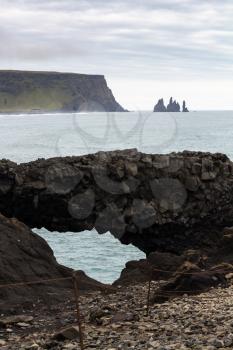 travel to Iceland - volcanic stone arch on Kirkjufjara beach near Vik I Myrdal village on Atlantic South Coast in Katla Geopark in september