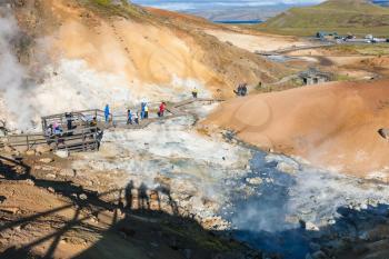 travel to Iceland - people at viewpoint in geothermal Krysuvik area on Southern Peninsula (Reykjanesskagi, Reykjanes Peninsula) in september
