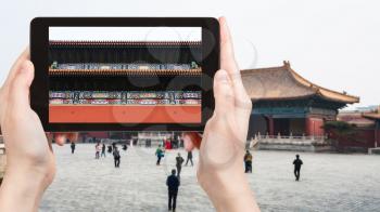 travel concept - tourist photographs courtyard of Imperial Ancestral Temple (Taimiao, Working People's Cultural Palace) in Beijing Imperial city in spring on tablet