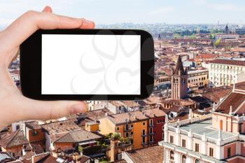 travel concept - tourist photographs Verona city skyline from tower Torre dei Lamberti in spring on smartphone with cut out screen for advertising logo