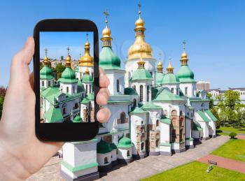travel concept - tourist photographs Saint Sophia (Holy Sophia, Hagia Sophia) Cathedral in Kiev city in Ukraine on smartphone
