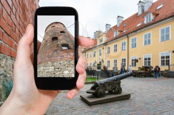 travel concept - tourist photographs Powder Tower, the part of old town walls, in Riga city in Latvia in september on smartphone