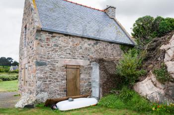 travel in France - typical stone Breton house in Plougrescant town of the Cotes-d'Armor department in Brittany in rainy summer day