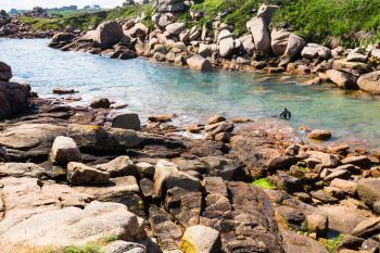 travel to France - diver in Ploumanac'h site of Perros-Guirec commune on Pink Granite Coast of Cotes-d'Armor department in the north of Brittany in sunny summer day