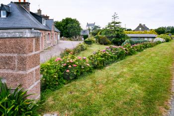 travel to France - street with flowerbed in Ploubazlanec commune of Paimpol region in Cotes-d'Armor department of Brittany in summer eveining