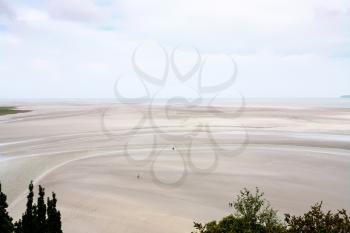 Travel to France - above view of muddy tidal bay in low tide near Le Mont Saint-Michel island in Normandy