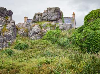 travel in France - rock and stone Breton house in Plougrescant town of the Cotes-d'Armor department in Brittany in rainy summer day