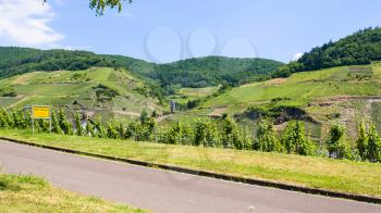 travel to Germany - road and vineyards along Mosel river in Cochem - Zell county on Moselle wine route in summer day (Text on the road sign: town Zell/Mosel, region Kaimt, county Cochem - Zell)