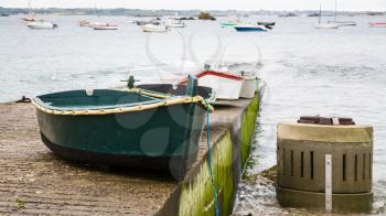 travel in France - boats on pier at beach of Gouffre gulf of English Channel near Plougrescant town of the Cotes-d'Armor department in Brittany in summer