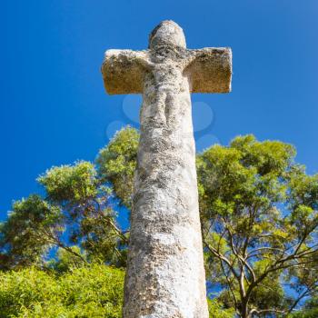 travel to France - old stone celtic cross near Saint-Guirec beach of Perros-Guirec commune on Pink Granite Coast of Cotes-d'Armor department in the north of Brittany in sunny summer morning