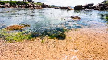 travel to France - pebble beach in Ploumanac'h site of Perros-Guirec commune on Pink Granite Coast of Cotes-d'Armor department in the north of Brittany in sunny summer day