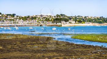 travel to France - view of Perros-Guirec commune through estuary of river Kerduel and bay Anse de Perros in Cotes-d'Armor department in the north of Brittany in sunny summer day