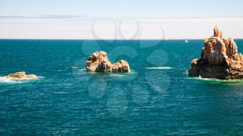 travel to France - granite rocks in ocean on shore of Ile-de-Brehat island in Cotes-d'Armor department of Brittany in summer sunny day