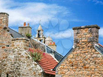 travel to France - typical breton country houses and bell tower of church Eglise paroissiale Notre-Dame de Bonne-Nouvelle on Ile-de-Brehat island in Cotes-d'Armor department of Brittany in summer